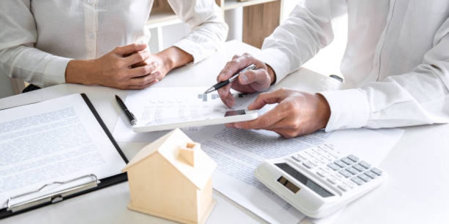 assessor Real estate broker agent presenting and consult to customer to decision making sign insurance form agreement, home model, concerning mortgage loan offer for and house insurance.